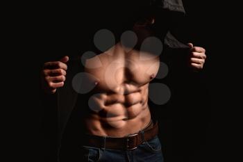Muscular sexy bodybuilder on dark background�