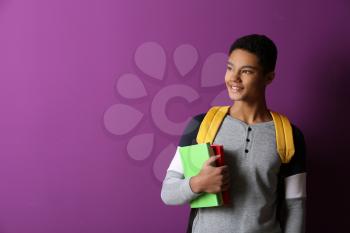 African-American schoolboy on color background�