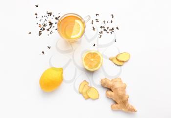 Glass of healthy drink with ginger and lemon on white background�