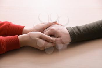 Hands of woman comforting her friend on white background�