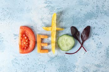 Word DETOX made of fresh vegetables on color background�