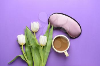 Composition with sleep mask, flowers and coffee on color background�