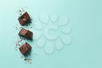 Sweet tasty chocolate on color background�