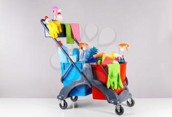Set of cleaning supplies on light background�