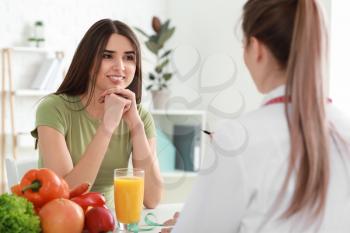 Young woman visiting nutritionist in weight loss clinic�