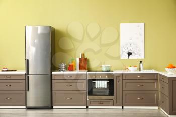 Big modern fridge in interior of kitchen�