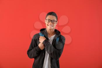 Portrait of African-American teenage boy on color background�