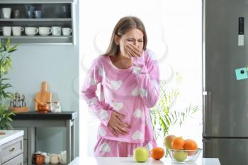 Pregnant woman suffering from toxicosis at home�