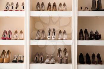 Collection of new female shoes on shelves in shop�