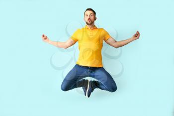 Funny jumping man on color background�