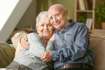 Portrait of happy senior couple at home�