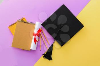 Mortar board, diploma and stationery on color background. Concept of high school graduation�