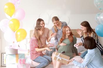 Beautiful pregnant woman and her friends at baby shower party�