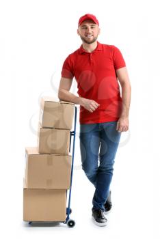 Handsome delivery man with boxes on white background�