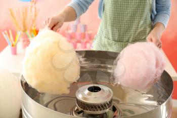 Woman making cotton candy at fair�