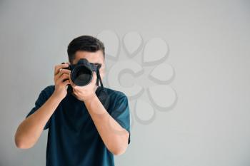 Male photographer on light background�