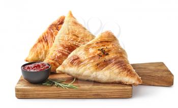 Delicious samosas and sauce on white background�