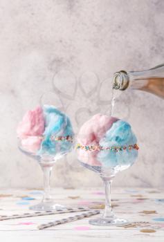 Preparing of tasty cotton candy cocktail on white table�