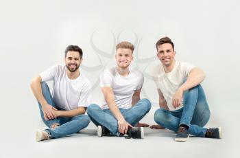 Handsome young men on light background�