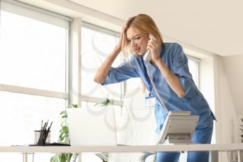 Stressed female medical assistant with a lot of work in clinic�