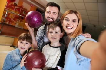 Family taking selfie at bowling club�