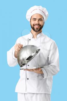 Handsome male chef on color background�