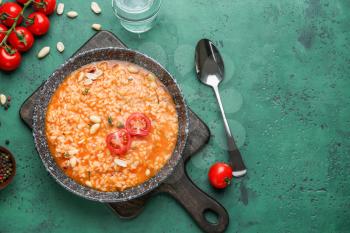 Plate with tasty risotto on color background�