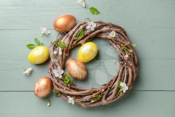 Nest with beautiful Easter eggs on wooden background�