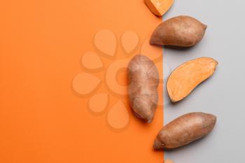 Fresh sweet potatoes on color background�