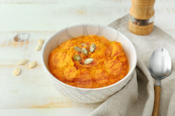 Bowl with mashed sweet potato on wooden table�