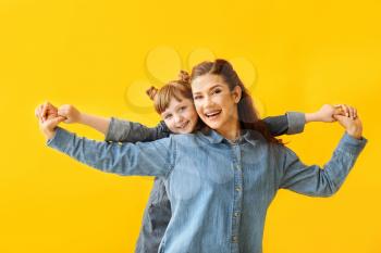 Portrait of woman with little adopted girl on color background�