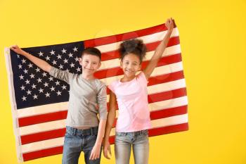 Cute children with national flag of USA on color background�