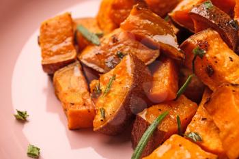 Tasty cooked sweet potato on plate, closeup�