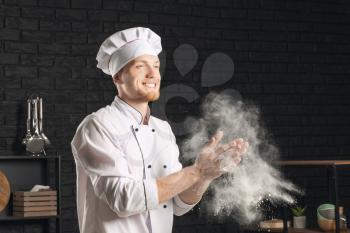 Male chef clapping hands with flour in kitchen�