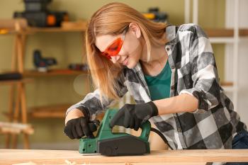 Female carpenter working in shop�