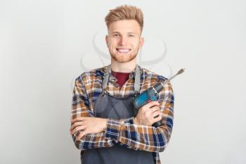 Male carpenter on grey background�