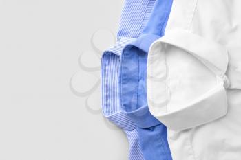 Shirts after dry-cleaning on light background�