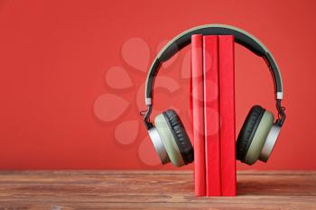 Books and modern headphones on table. Concept of audiobook�