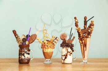 Delicious freak shakes on table against grey background�