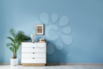 Chest of drawers near color wall in room�