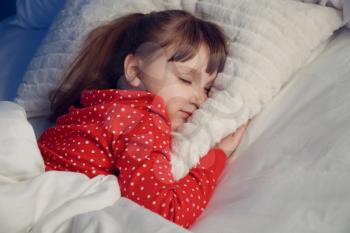 Cute little girl sleeping in bed at night�