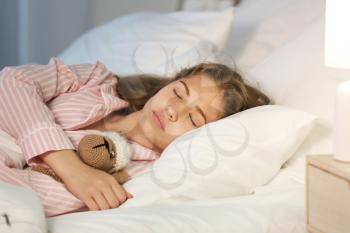 Teenage girl sleeping in bed at night�