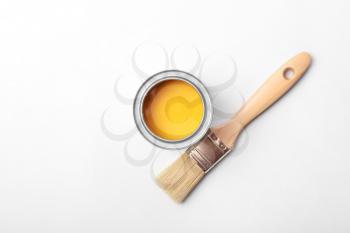 Can of paint and brush on white background�