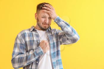 Man having panic attack on color background�