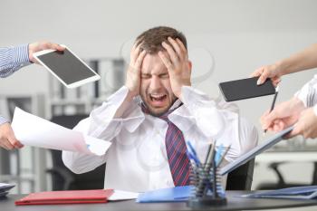 Overworked businessman having panic attack in office�