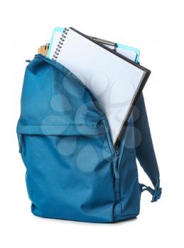 School backpack with stationery on white background�