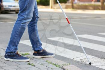 Blind mature man crossing road outdoors�