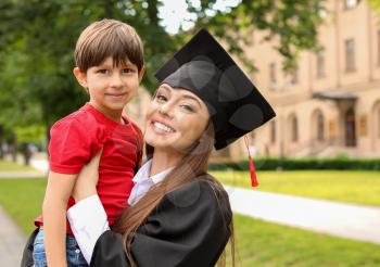 Woman with little son on her graduation day�