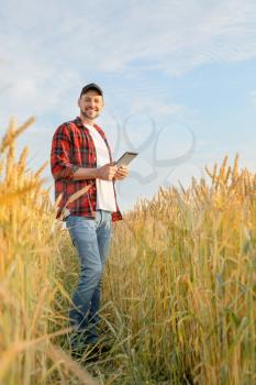 Farmer in field on sunny day�