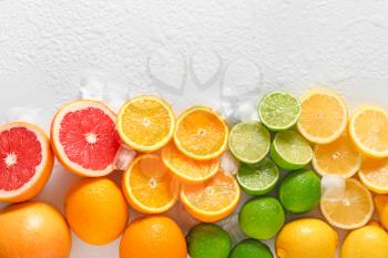 Different cut citrus fruits on white background�